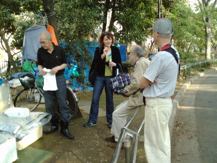 Filmmaker Radovan Tadic w his assistant Judit Kawaguchi interviewing the homeless in Tokyo